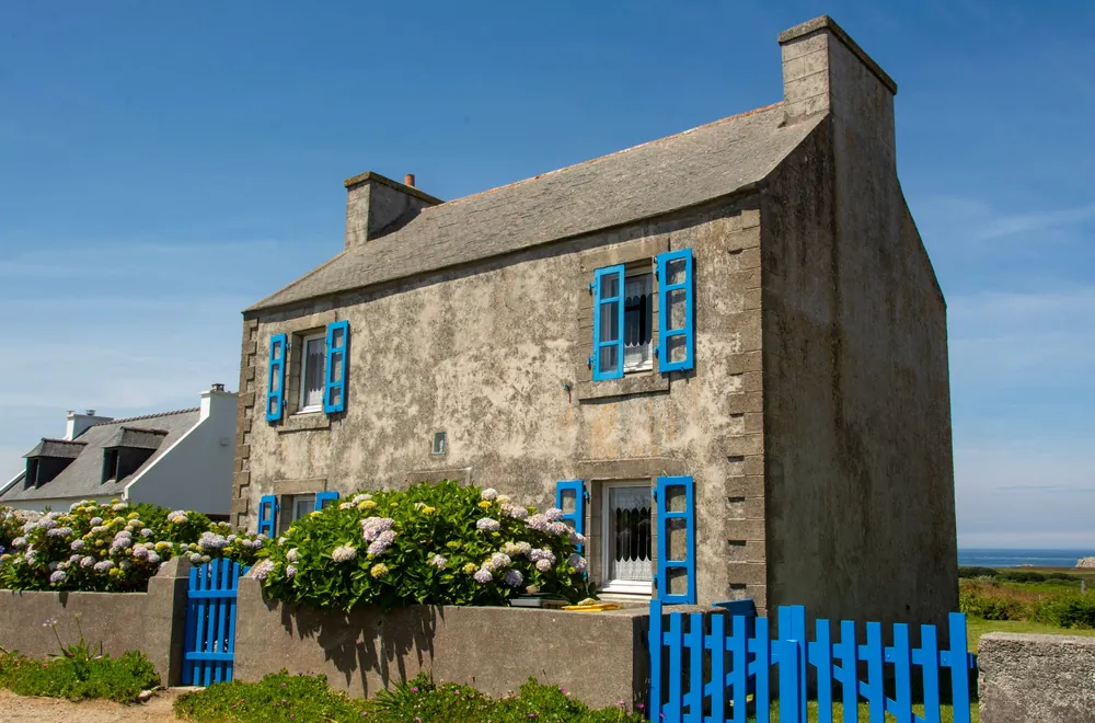 Maison bretonne en pierre aux volets bleus, dans le pays de Morlaix